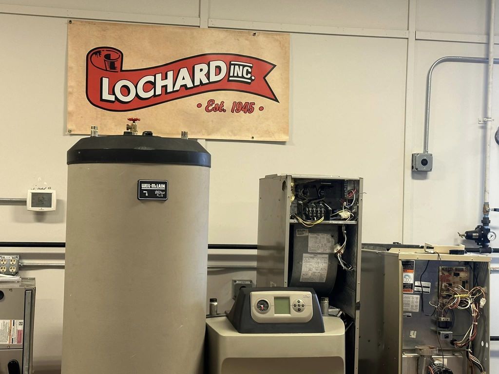 Air conditioning equipment with "Lochard Inc" sign on wall